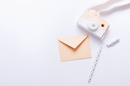 Wooden camera for kids, envelope and pen on white backgroundの写真素材