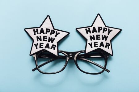 Festive New Year glasses on blue backgroundの写真素材