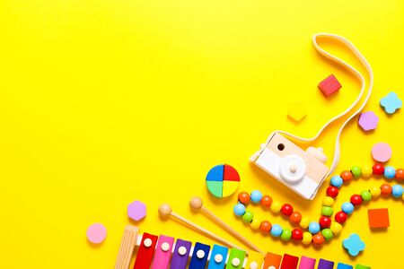 Colorful kids toys on yellow background with copy space. Top view, flat lay.の写真素材