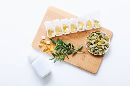 Assorted pharmaceutical medicine vitamins, pills, drugs in plastic container on white backgroundの写真素材