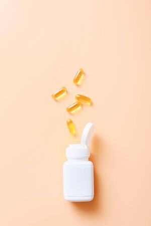 Fish oil vitamin capsules on light color backgroundの写真素材