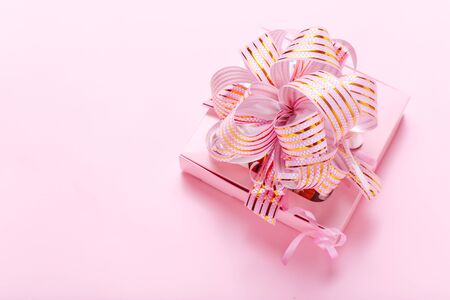 Holiday pink background with gift box. Valentines Day, Happy Womens Day, Mothers Day, Birthday, Wedding, Christmas. Space for textの写真素材