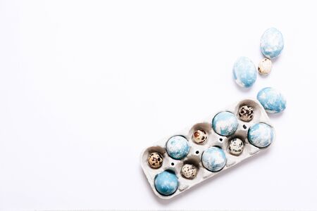 Stylish background of Easter eggs in cardboard egg case on white background, copy spaceの写真素材
