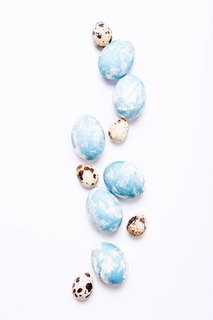 Stylish eggs with ombre blue marble stone effect on white backgroundの写真素材