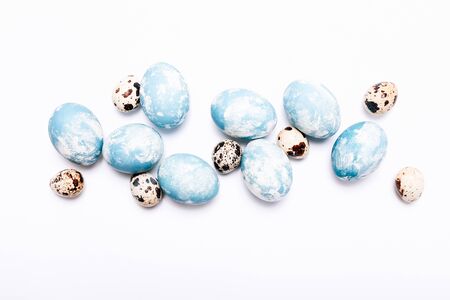 Stylish eggs with ombre blue marble stone effect on white backgroundの写真素材