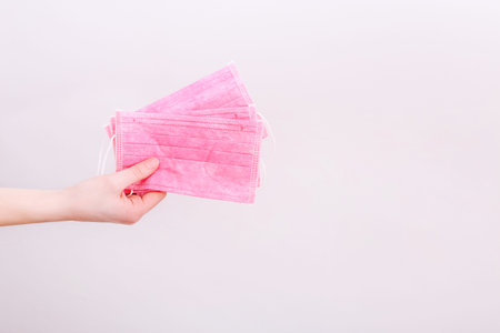 Medical mask, Medical protective mask in hand on blue background. Healthcare and medical concept.
