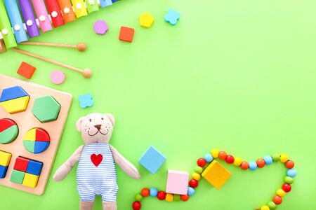 Colorful kids toys on green background. Top viewの写真素材