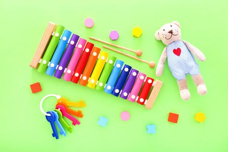 Colorful kids toys on green background. Top view, copy spaceの写真素材