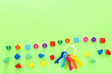 Colorful kids toys on green background. Top view