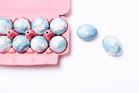 Easter eggs painted in blue colors on a white backgroundの写真素材