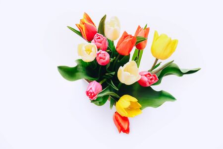 Beautiful tulips in vase on white background, top viewの写真素材