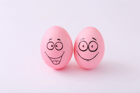 Funny pink eggs with face feeling on white background