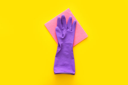 Colorful cleaning set for different surfaces in kitchen on yellow background. Top viewの写真素材