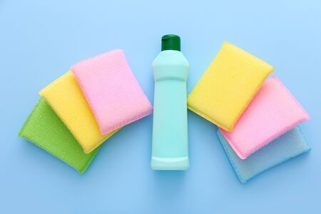 Colorful kitchen sponges on blue background. Cleaning setの写真素材