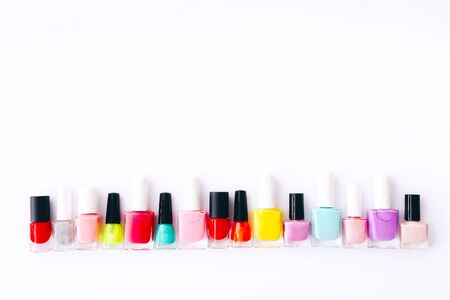 Group of nail polishes of different colors on white backgroundの写真素材