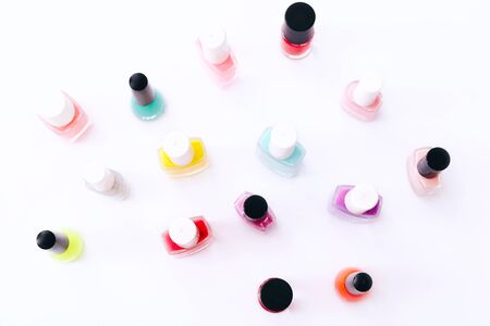 Group of nail polishes of different colors on white backgroundの写真素材