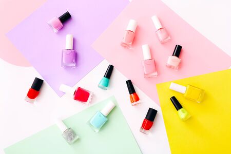 Group of nail polishes of different colors on colorful background.の写真素材