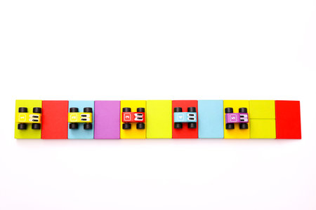Educational toys for kids. Colorful wooden cars with numbers on white background.