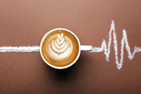 Cup of coffee and sugar on brown background, top view
