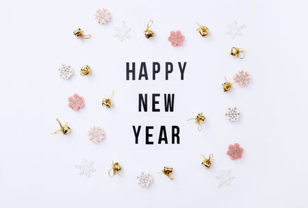 New Year celebration and festive background with golden decorations, top view.