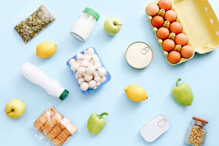 Set of grocery items from canned food, vegetables, cereal on blue background. Food delivery concept. Donation concept. Top view.の素材 [FY310157314174]