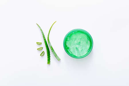 Organic aloe gel with aloe leaves on white background. Top viewの写真素材