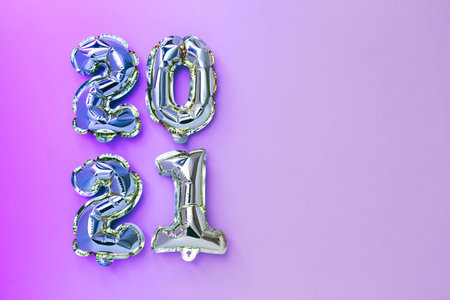 Foil balloons in the form of numbers 2021 with neon effect New year celebration.の写真素材