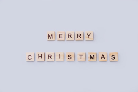 Merry Christmas. Wooden letters on gray background. Top view
