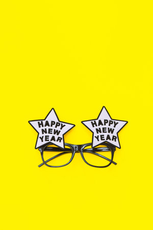 Happy new year glasses on yellow background, top viewの写真素材
