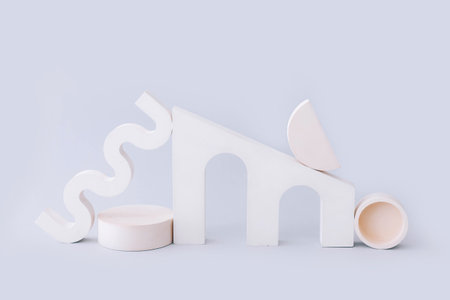 Abstract empty geometric shape podiums for product presentation on light gray background.