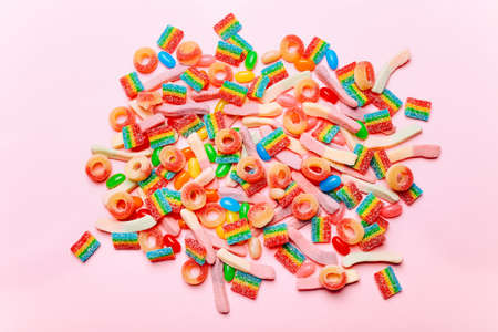 Mixed collection of colorful candy, on pink background. Flat lay, top viewの写真素材