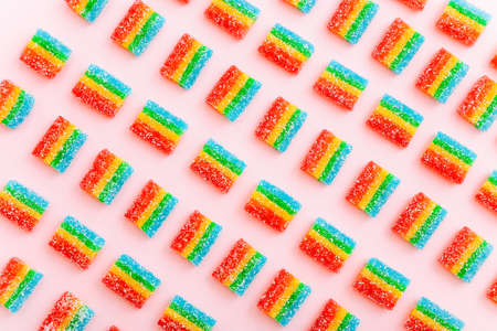 Rainbow juicy gummy candies background. Pattern from jelly sweets on pink backgroundの写真素材