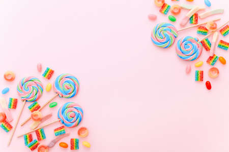 Mixed collection of colorful candy, on pink background. Flat lay, top viewの写真素材