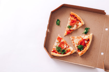 Pizza pieces in delivery box on white backgroundの写真素材