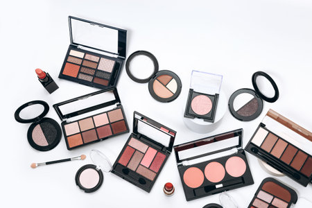 Makeup palettes with shadows and concealers. Make up products on white background