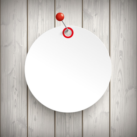 White paper circle sticker with red pin on the wooden background.  のイラスト素材