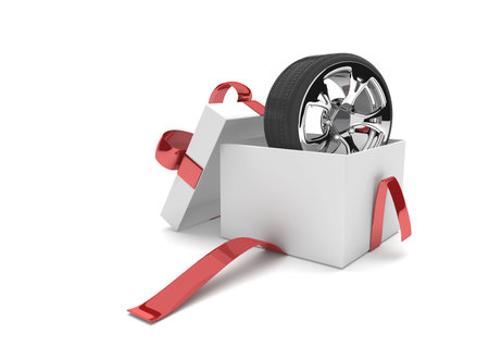 Opened gift carton with felly and tire on the white. 3d illustration.の写真素材