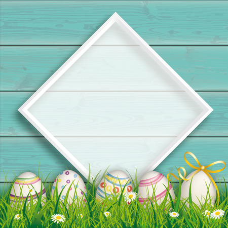 White frame on the wooden background with Easter eggs in the grass.のイラスト素材