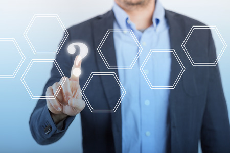 Man clicking the question mark on the big display.の写真素材