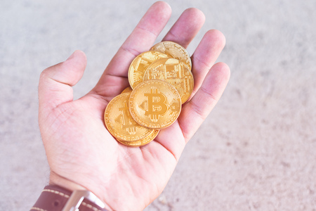 Golden bitcoin in the hand.の写真素材