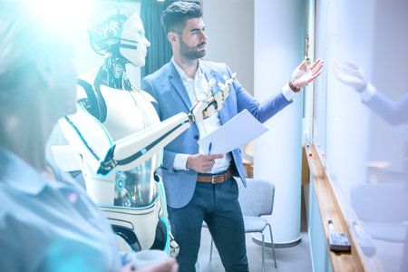 Businessmen and humanoid robot work on a project.