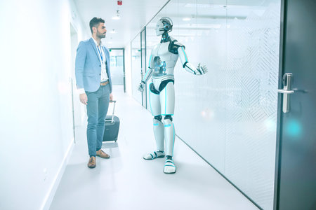 A humanoid robot shows the presenter around the company.