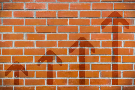 Brick wall with 4-step up arrowsの写真素材