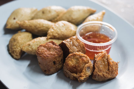 Deep fried crab meat roll and fish ball serve with sweet and spicy dipping sauce