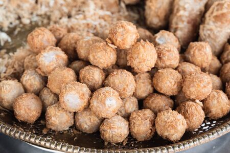 A lot of deep fried taro balls, sweet and creamy traditional dessert on a plateの写真素材