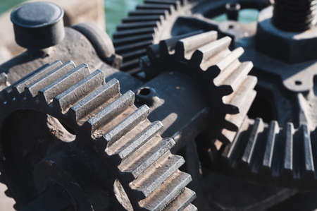 Old black mechanical cog on a flood gateの写真素材