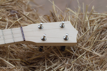 a part of light tone ukulele on straw stack backgroundの写真素材