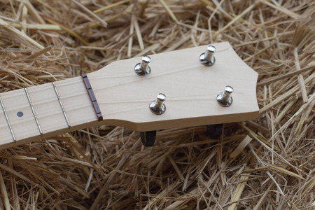 a part of light tone ukulele on straw stack backgroundの写真素材