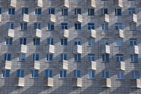 old facade of a soviet ussr concrete constructivism brutalism building with rectangular windows and...