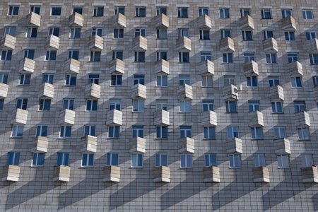 old facade of a soviet ussr concrete constructivism brutalism building with rectangular windows and...